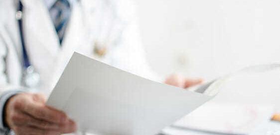 Picture of physician reading mail