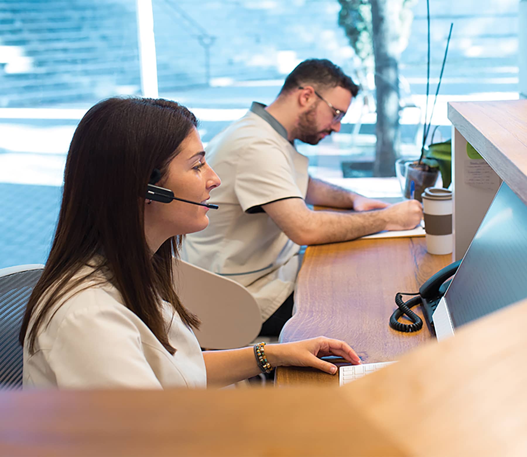Receptionists in a PT office greeting clients