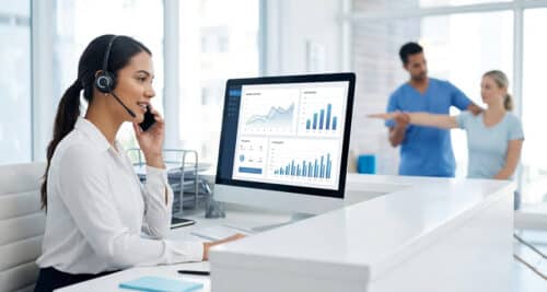 Physical therapy clinic receptionist answering a patient phone call while monitoring call tracking analytics and marketing performance data